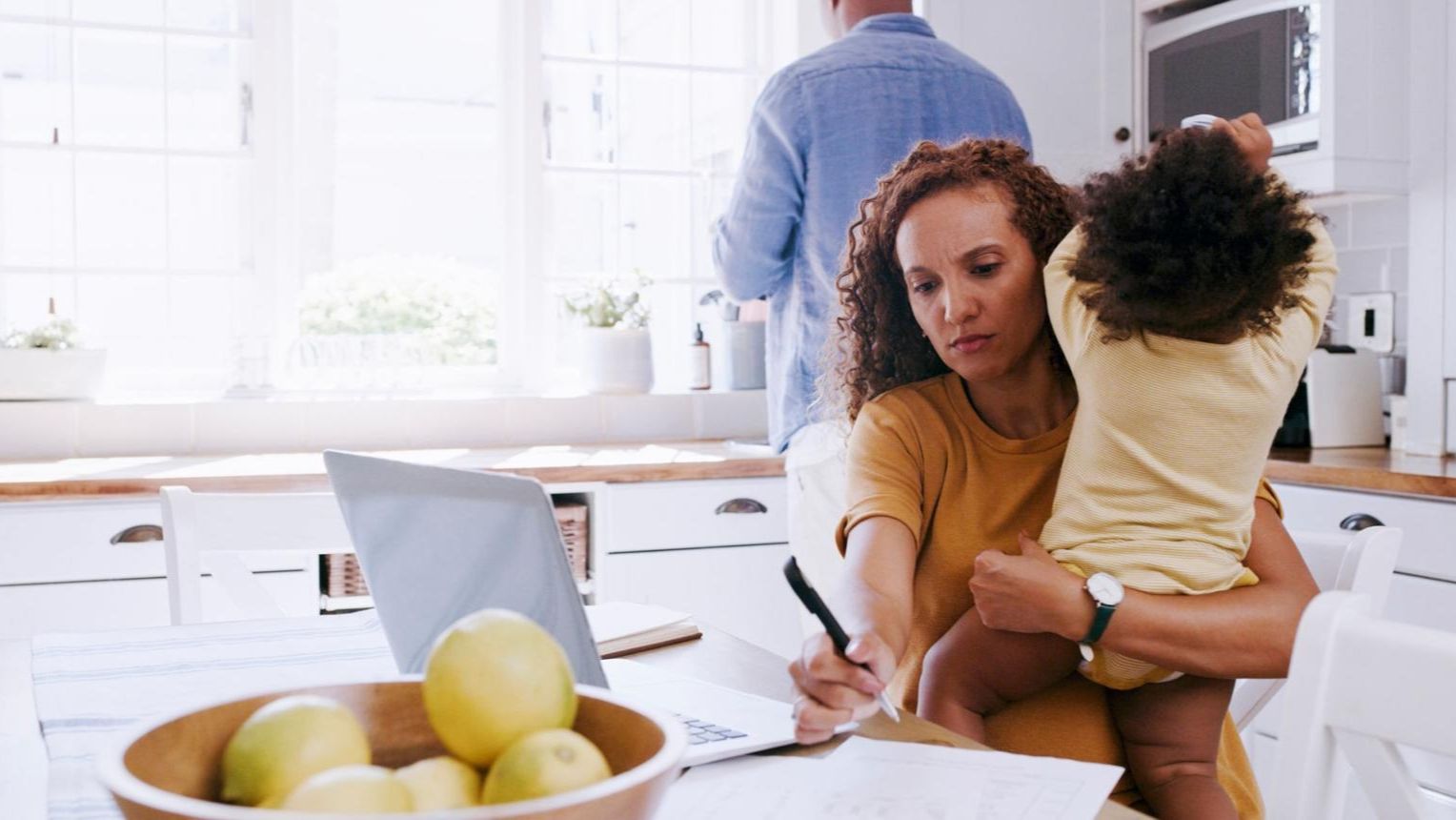 Young family discussing RRSP and tax planning at kitchen table