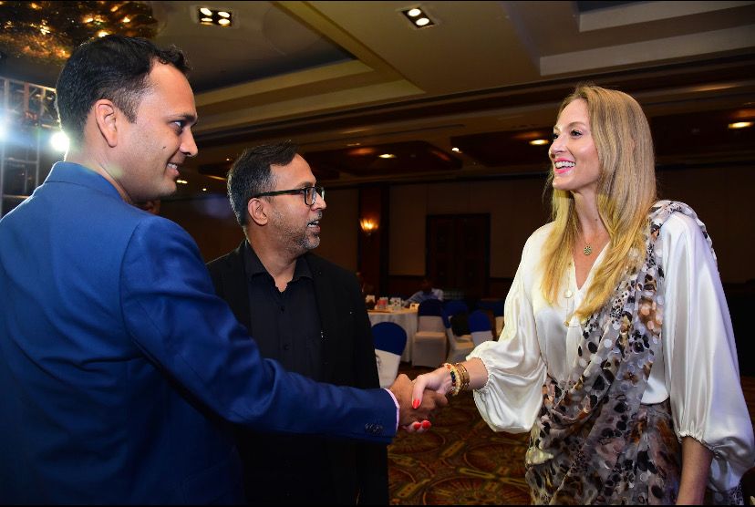 Taylor Elizabeth Perramond in a meeting, shaking hands