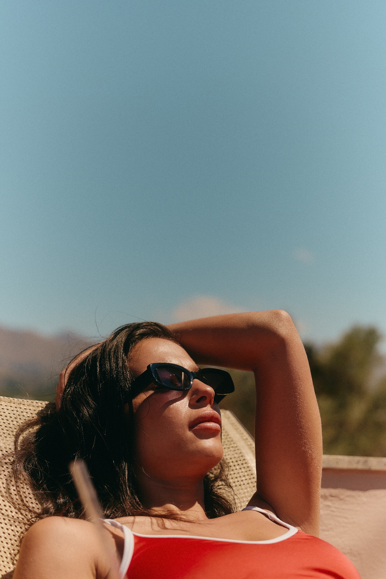 Woman relaxing in the sun on a lounger