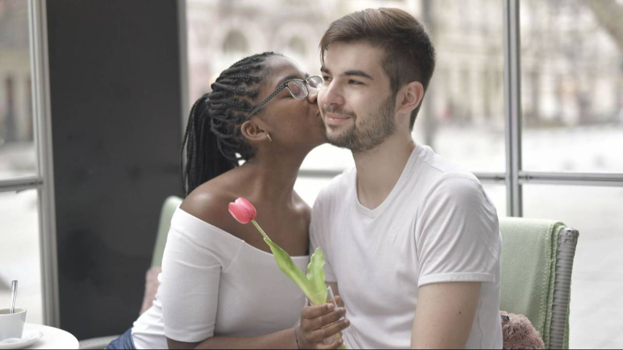 Woman kissing her partner on the cheek during a tender moment together