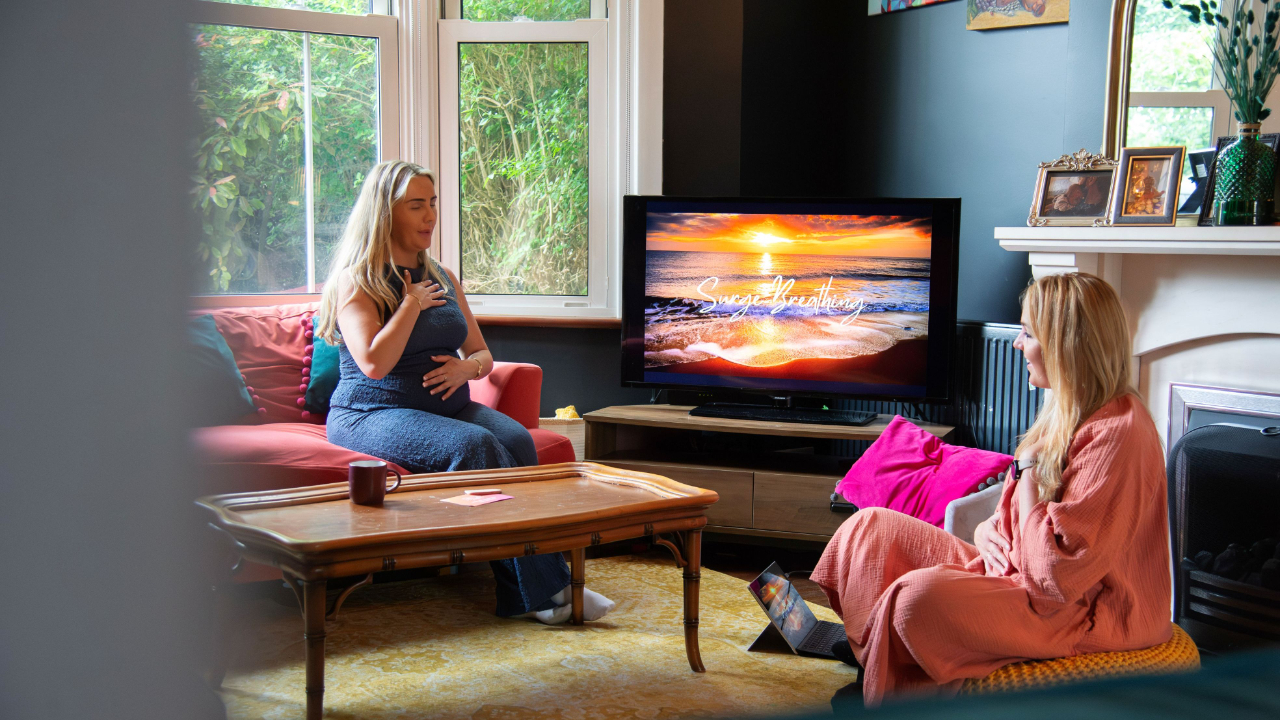 Hypnobirthing teacher supporting a pregnant client during a birth preparation session discussing labour and epidural options