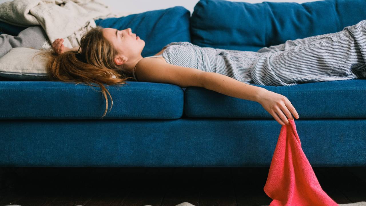 Woman touching her neck and shoulders, representing nervous system regulation and self-care during the luteal phase of PMDD