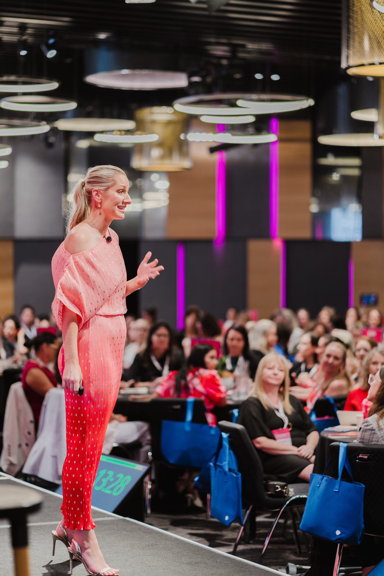 Ashleigh Conwell speaking to a full conference room