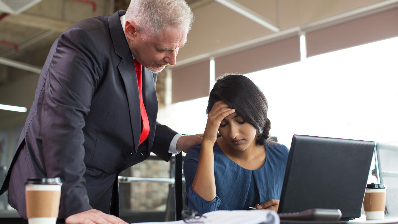 A manager checking on a colleague at work