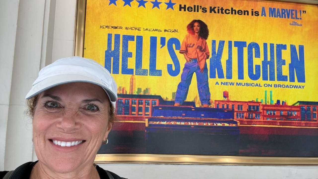 Women with white baseball cap in front of Hell's Kitchen poster in Broadway, NY