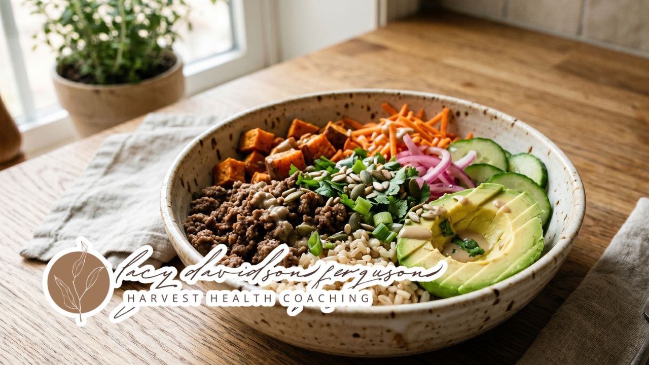 simple nourish bowl with protein vegetables avocado and rice on a table
