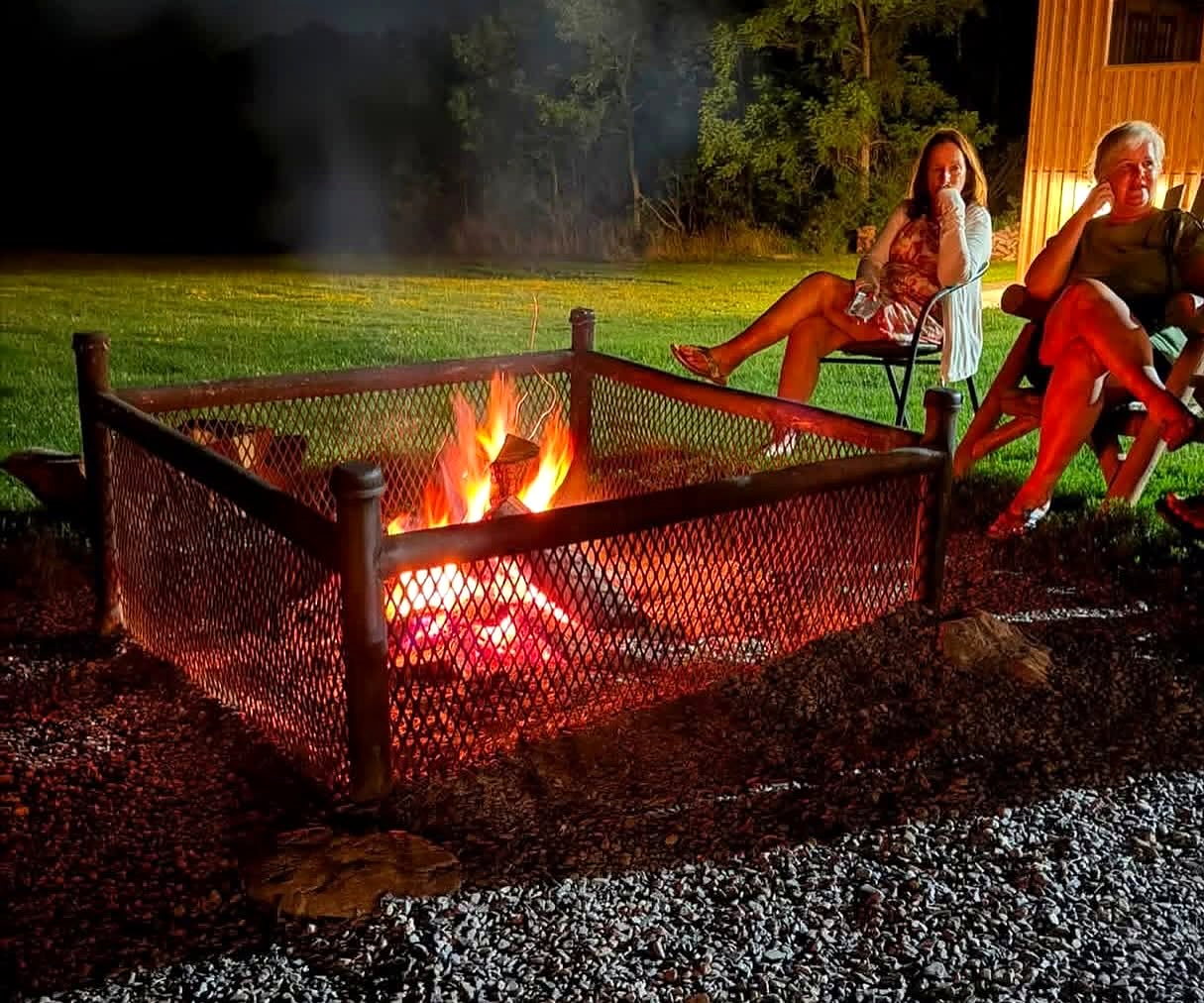 Wine Campers relaxing and talking together around an evening campfire