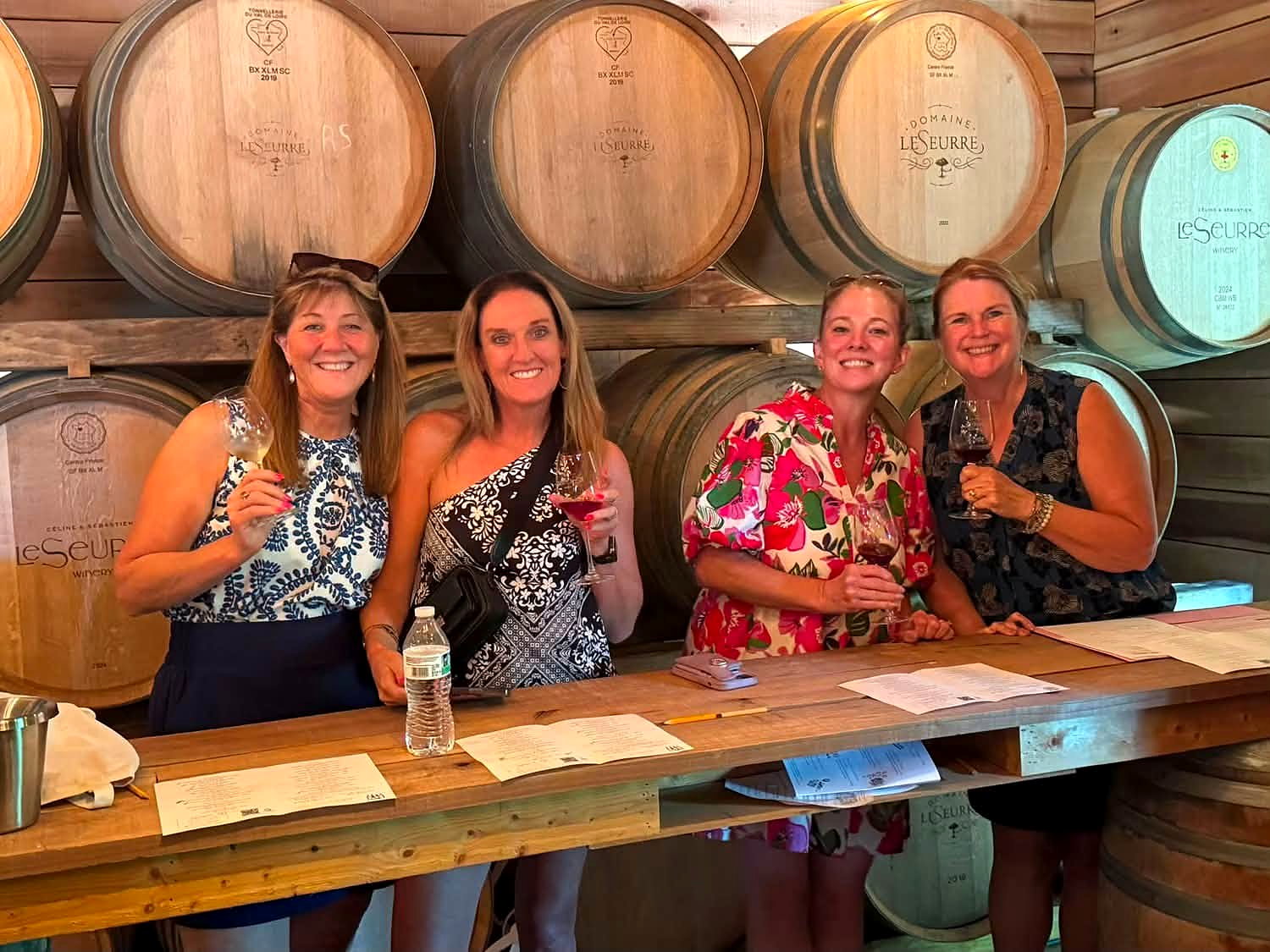 Wine Campers seated around a table for a barrel-room wine tasting