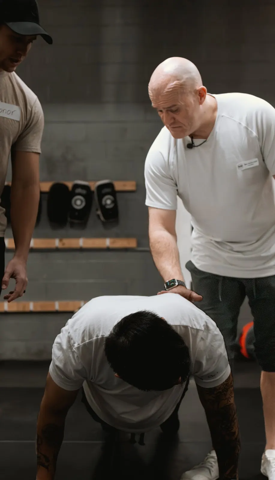 Ben McDonald guiding a client through a floor movement exercise