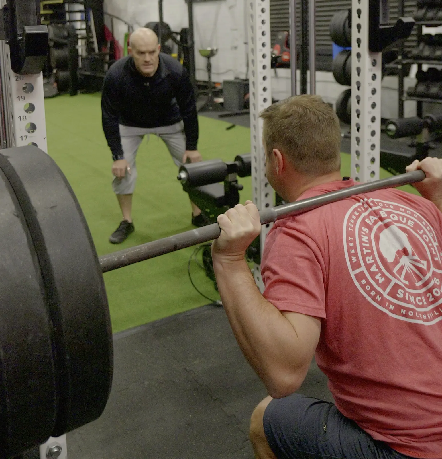 Ben McDonald watching a client's squat technique