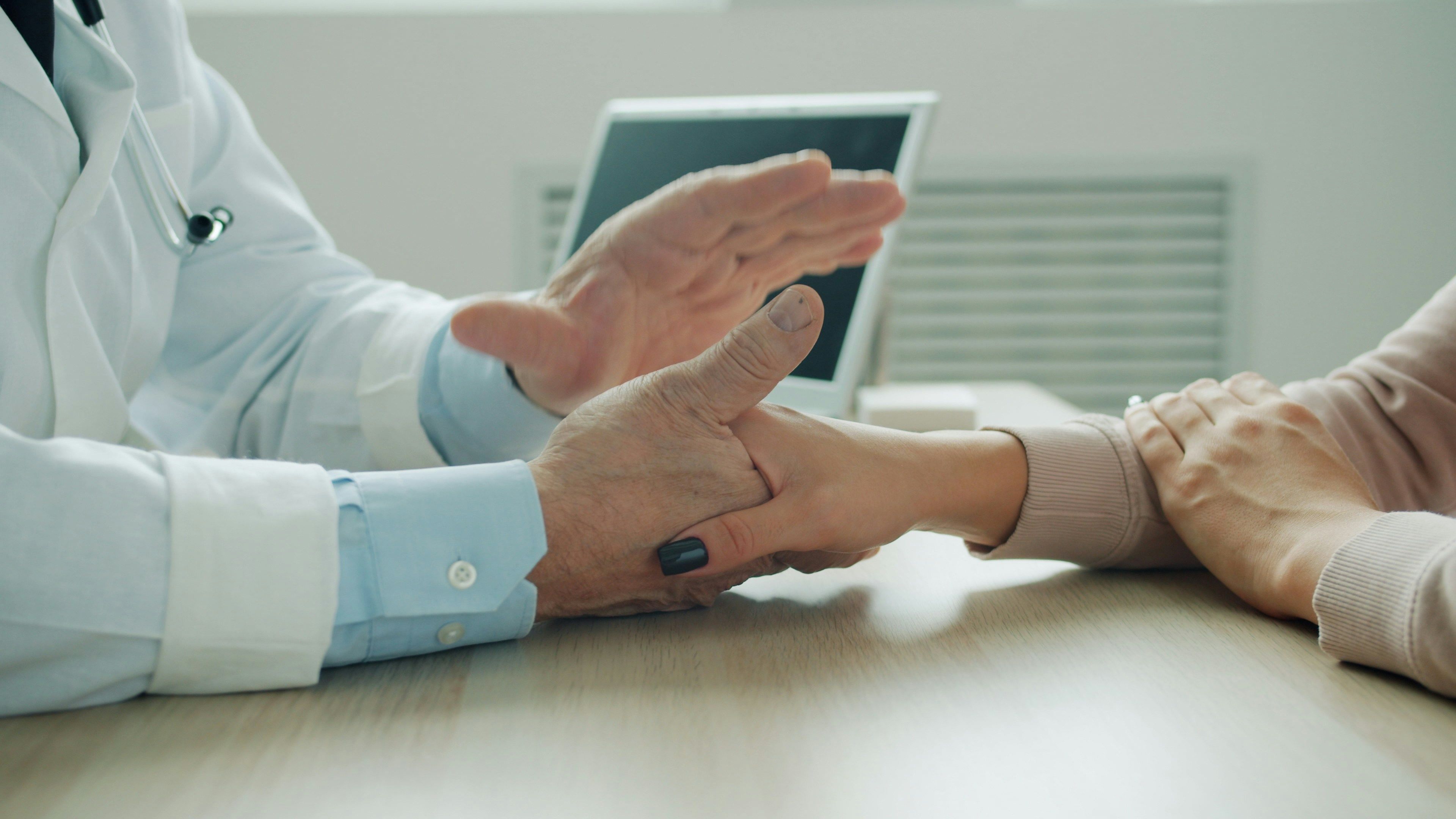 doctor and patient holding hands