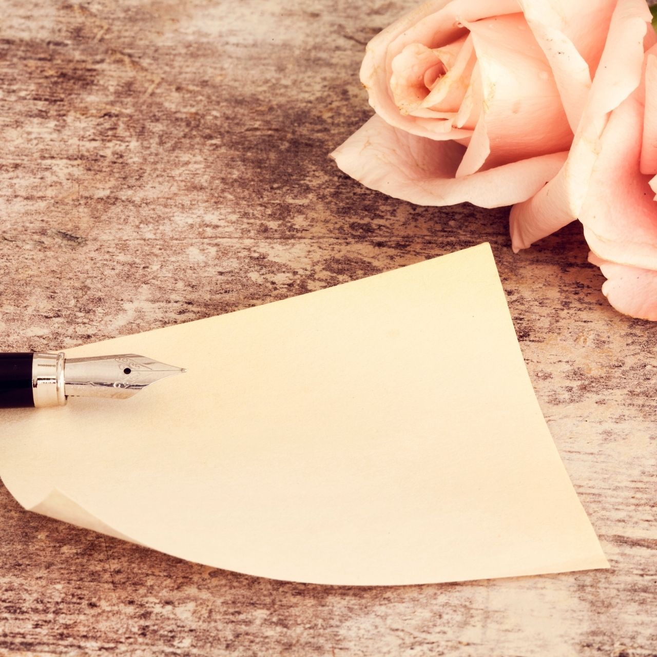 Photo-illustration of a pen, paper and a rose
