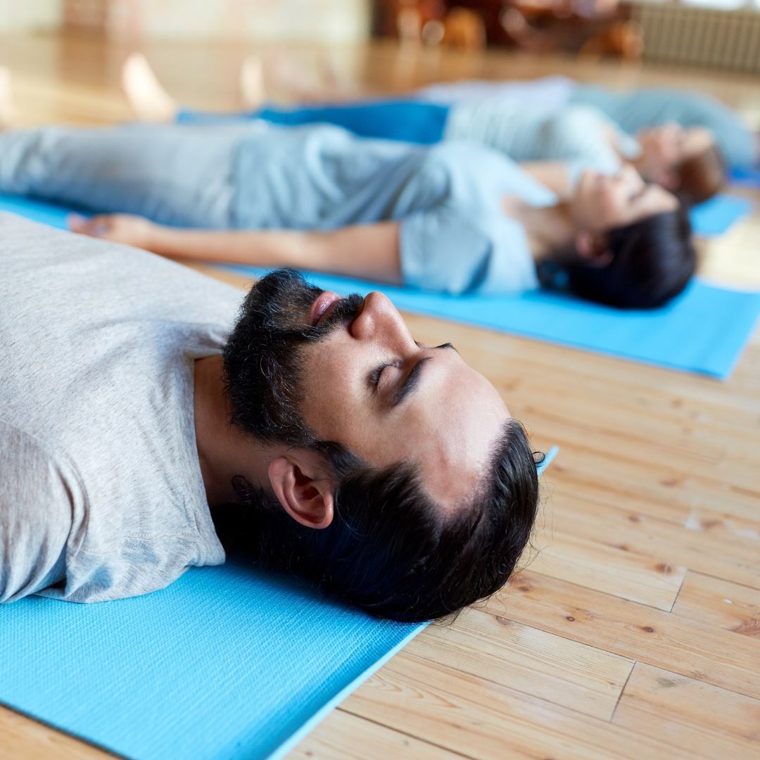 Group of people on blue yoga mats