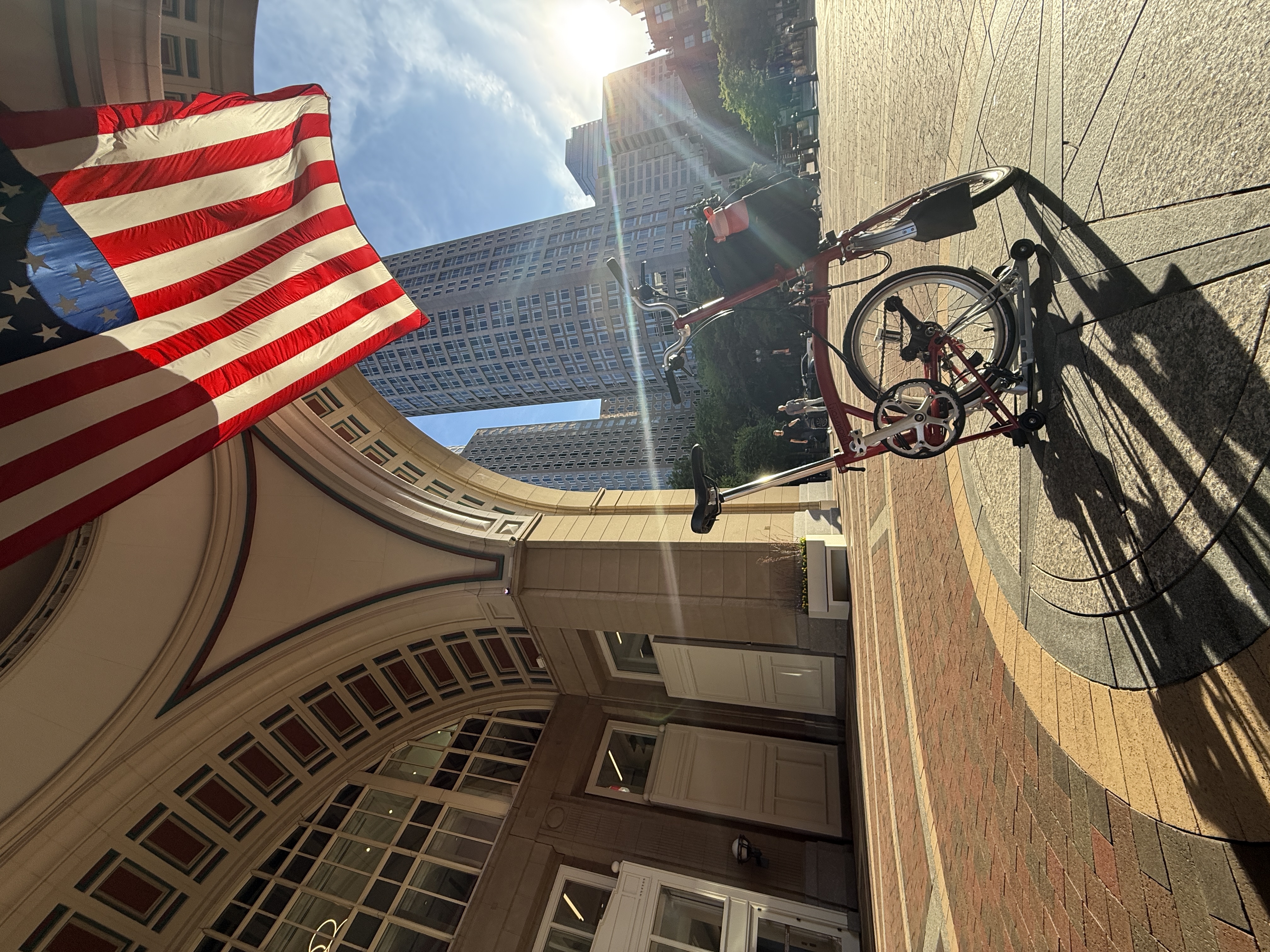 Bicycle parked beneath American flag
