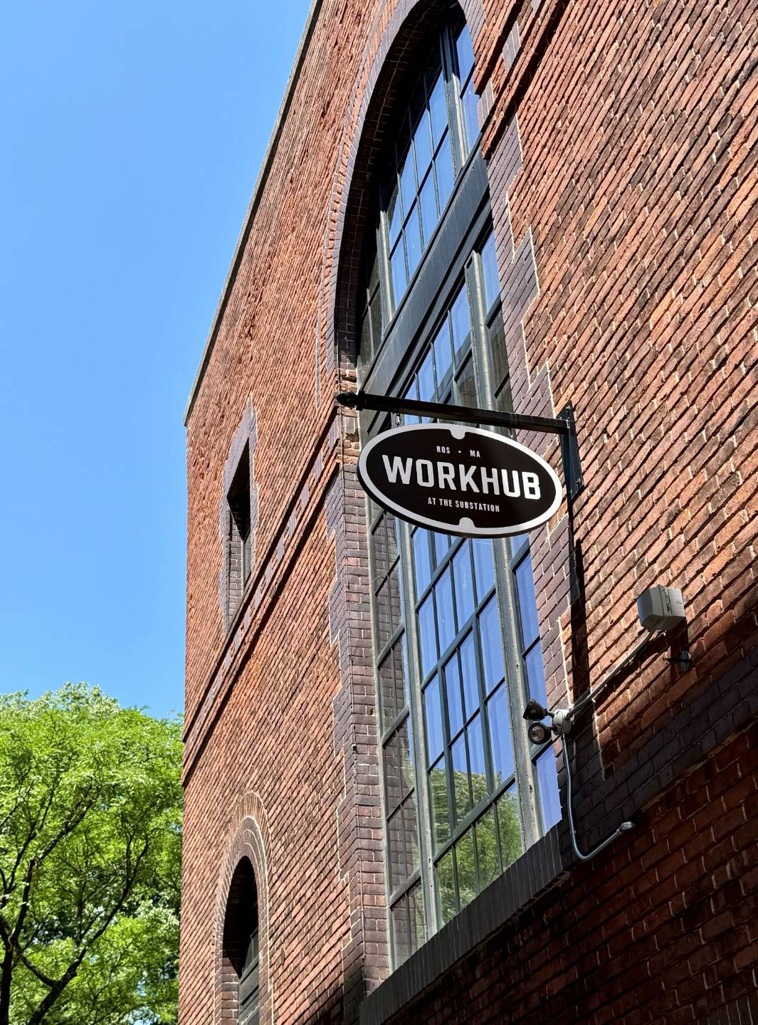 Workhub sign on red brick building with large arched windows