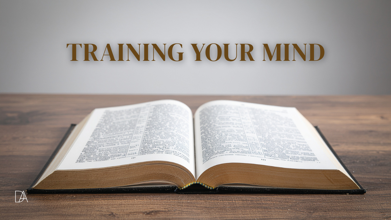 Open Bible resting on a wooden table with the words “Training Your Mind” displayed above it, symbolizing studying Scripture and renewing your thoughts.
