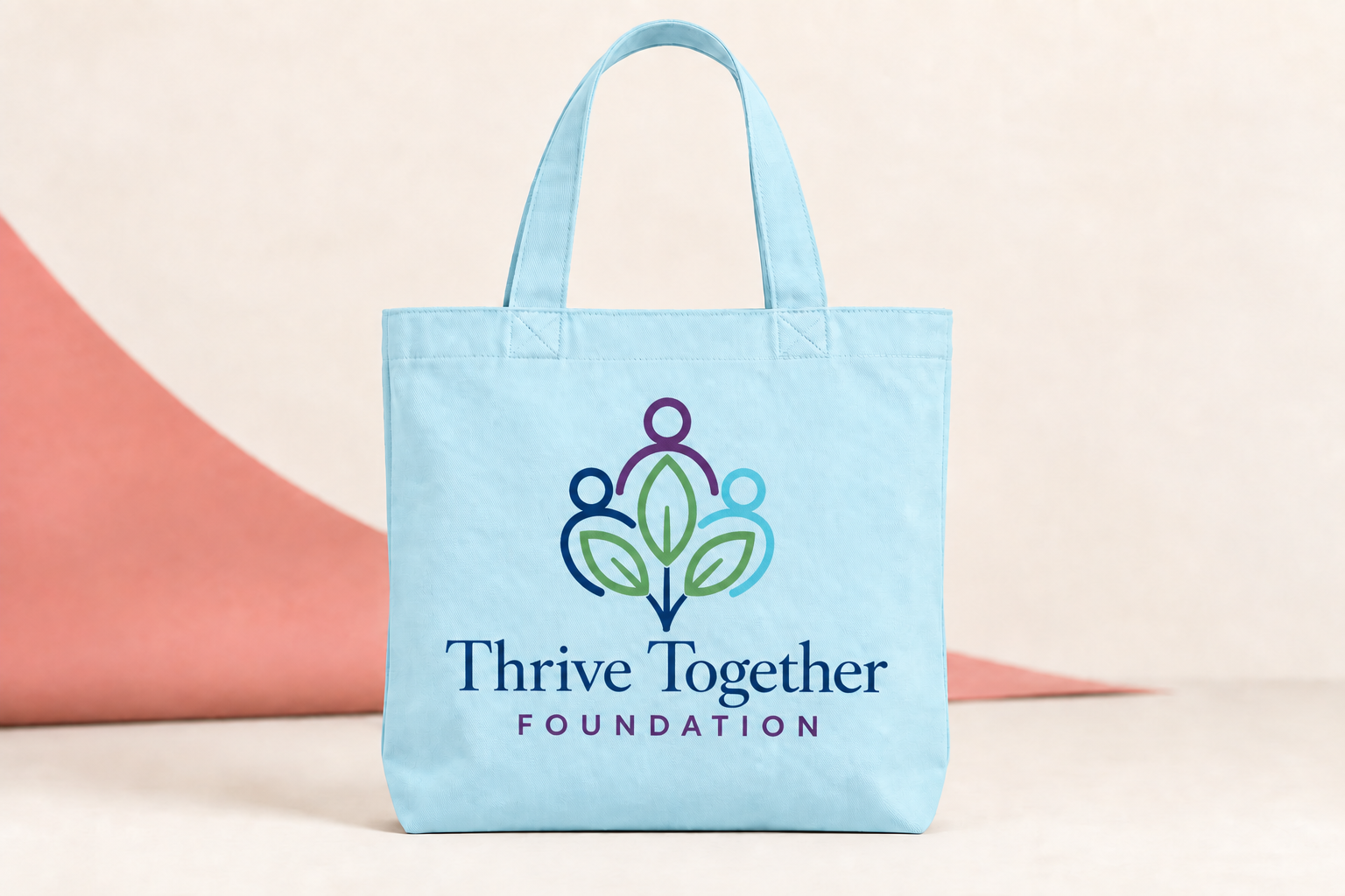 Pale-blue canvas tote with the people-and-plant logo printed directly on the fabric, without a rectangular background