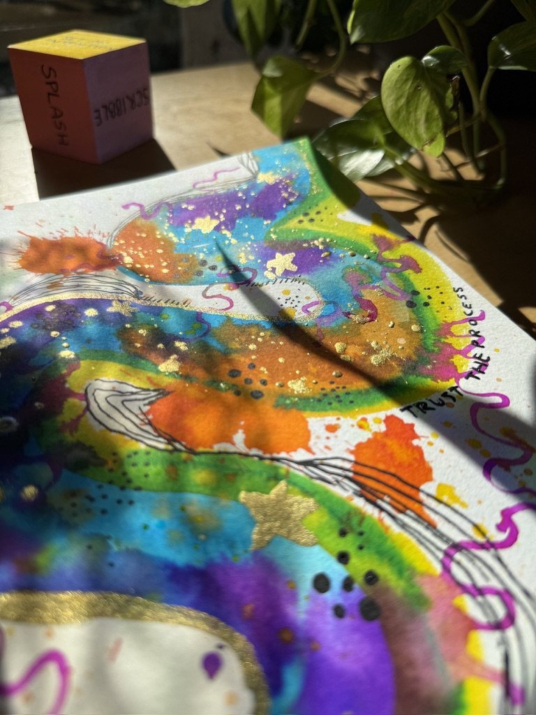 A close-up of the watercolour page with the words trust the process written along an edge