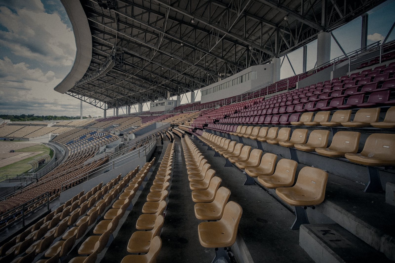 Empty stadium seating under a steel roof