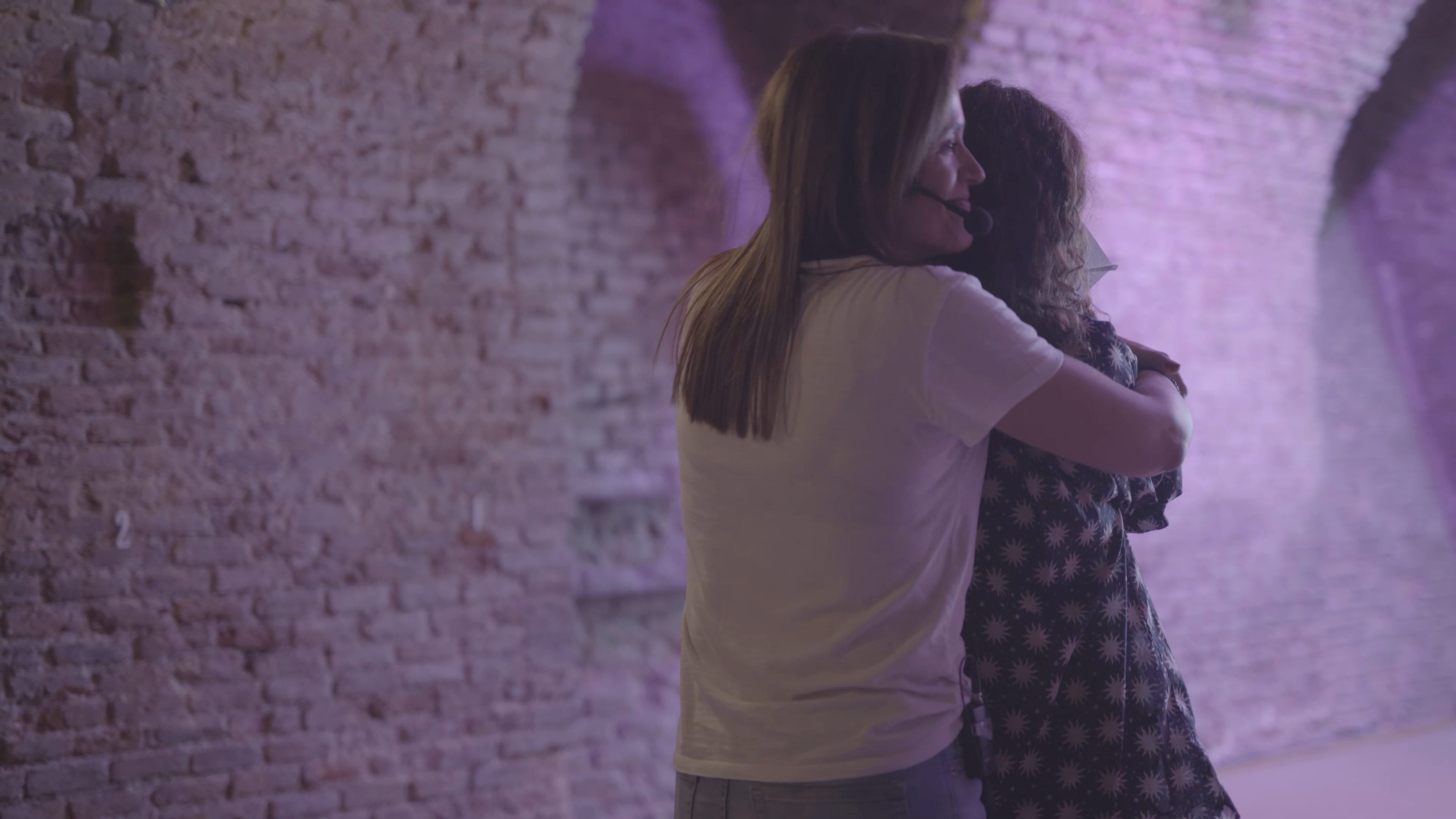 Marta Cea abrazando a una mujer del público durante una charla