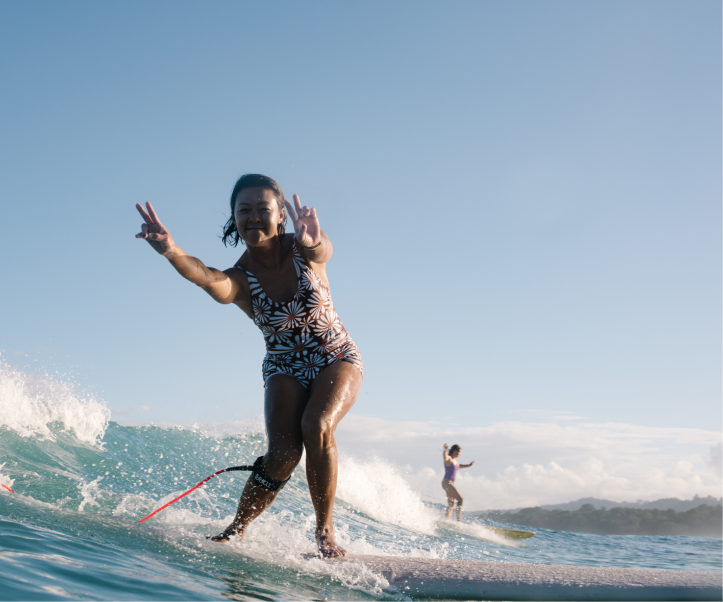 surf retreat group with colorful longboards, mindful surfing and mindset techniques for beginners and intermediates