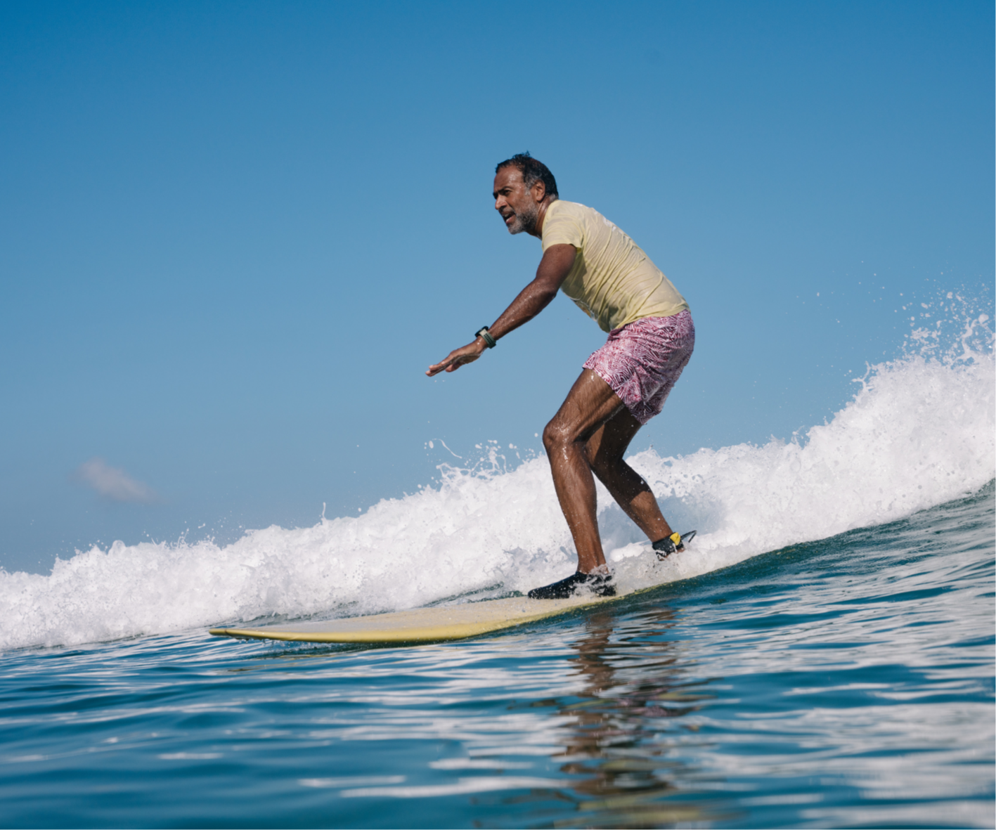 Mindful-Surfing-Techniques-for-Beginners, surf coach cheering in the water after best wave in lombok