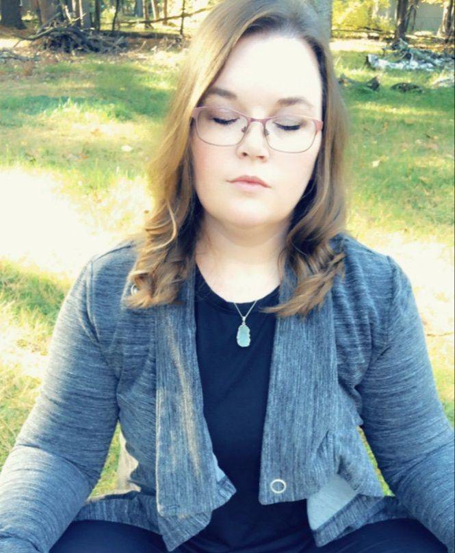 Carissa Andrews meditating outdoors