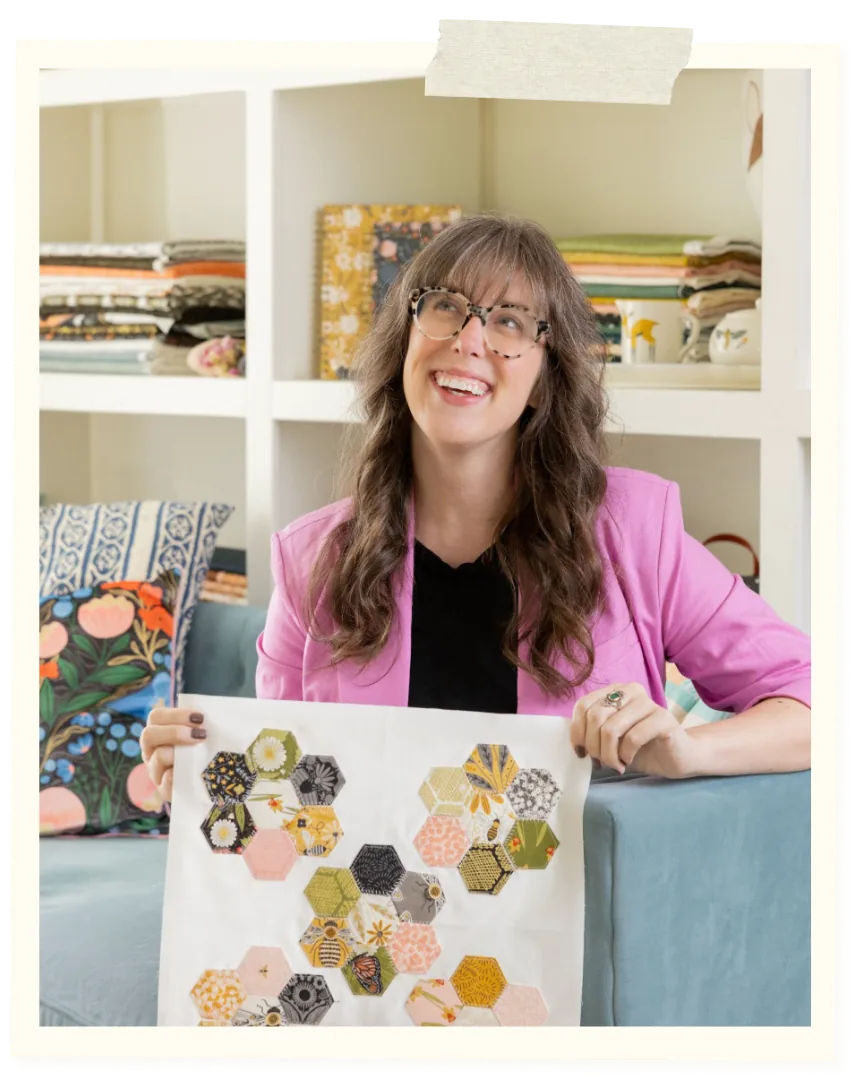 Stacie holding a hexagon quilt block