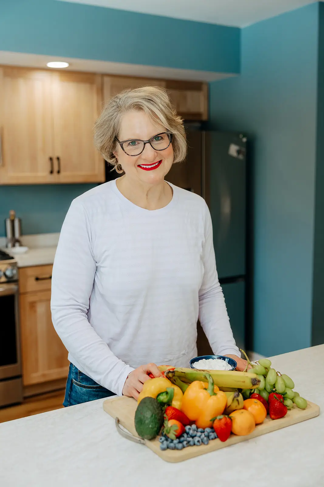 Sarah in her kitchen with fresh produce