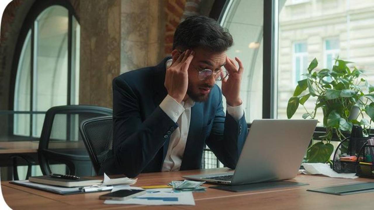 Stressed professional facing financial anxiety, representing why earning a high income does not equal financial security.