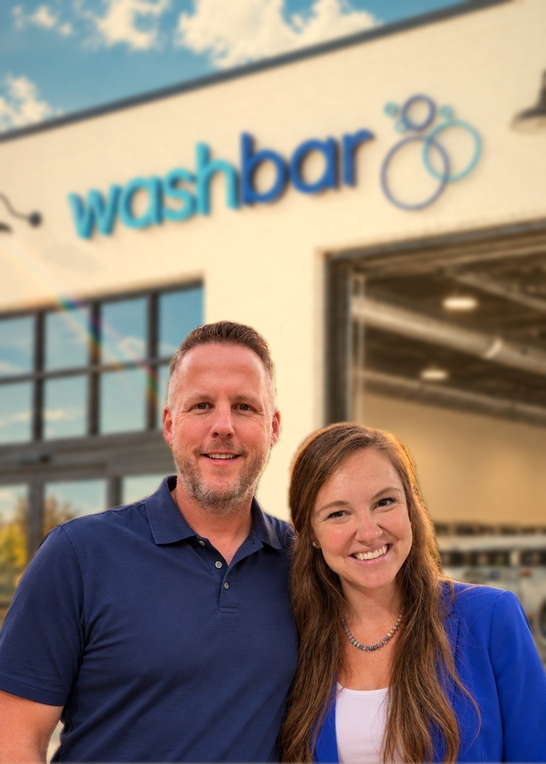 Josh and Hannah, founders of Laundry Advisors, in front of one of their laundromats