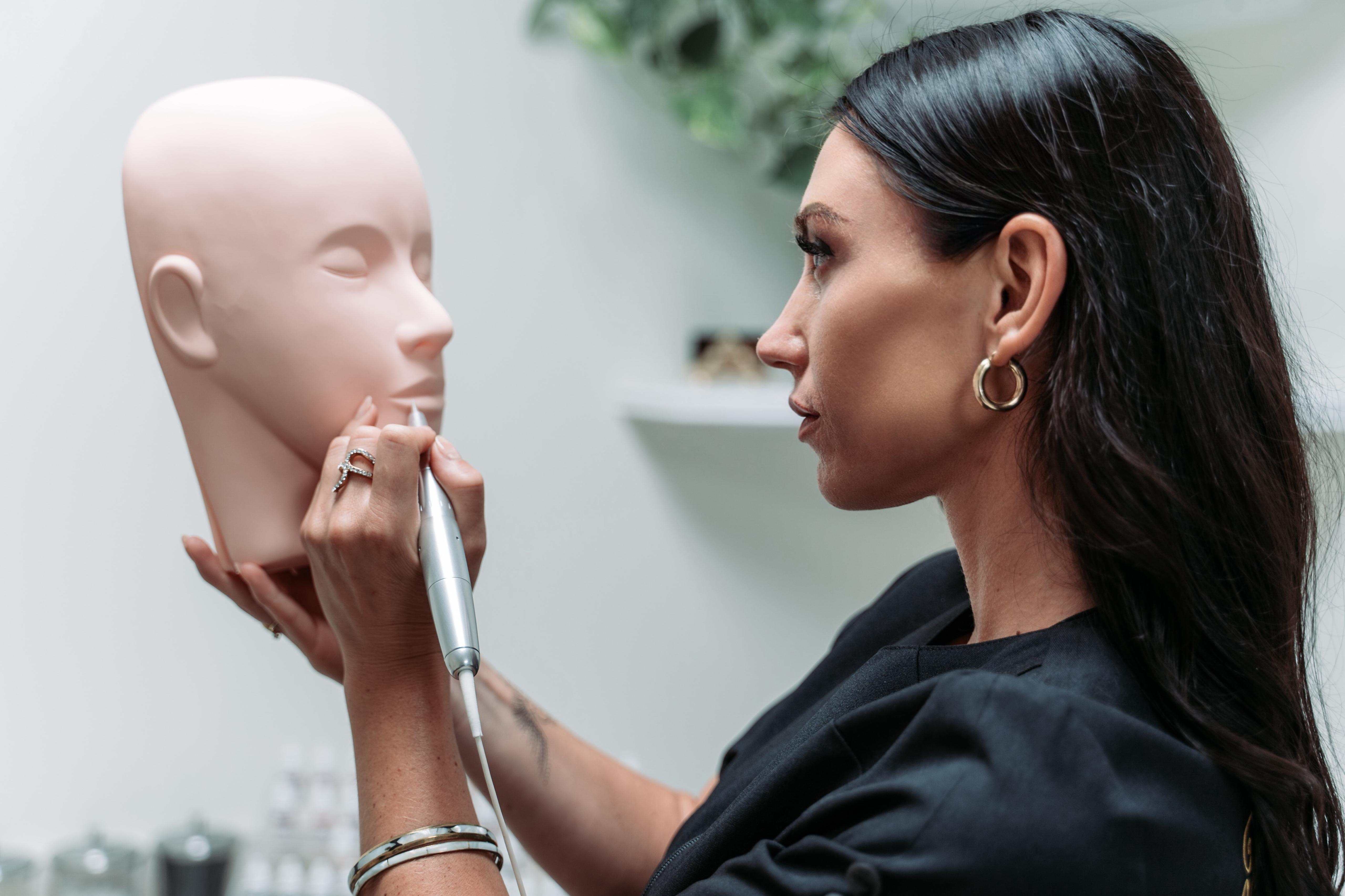 Taylor practising a brow stroke on a training head