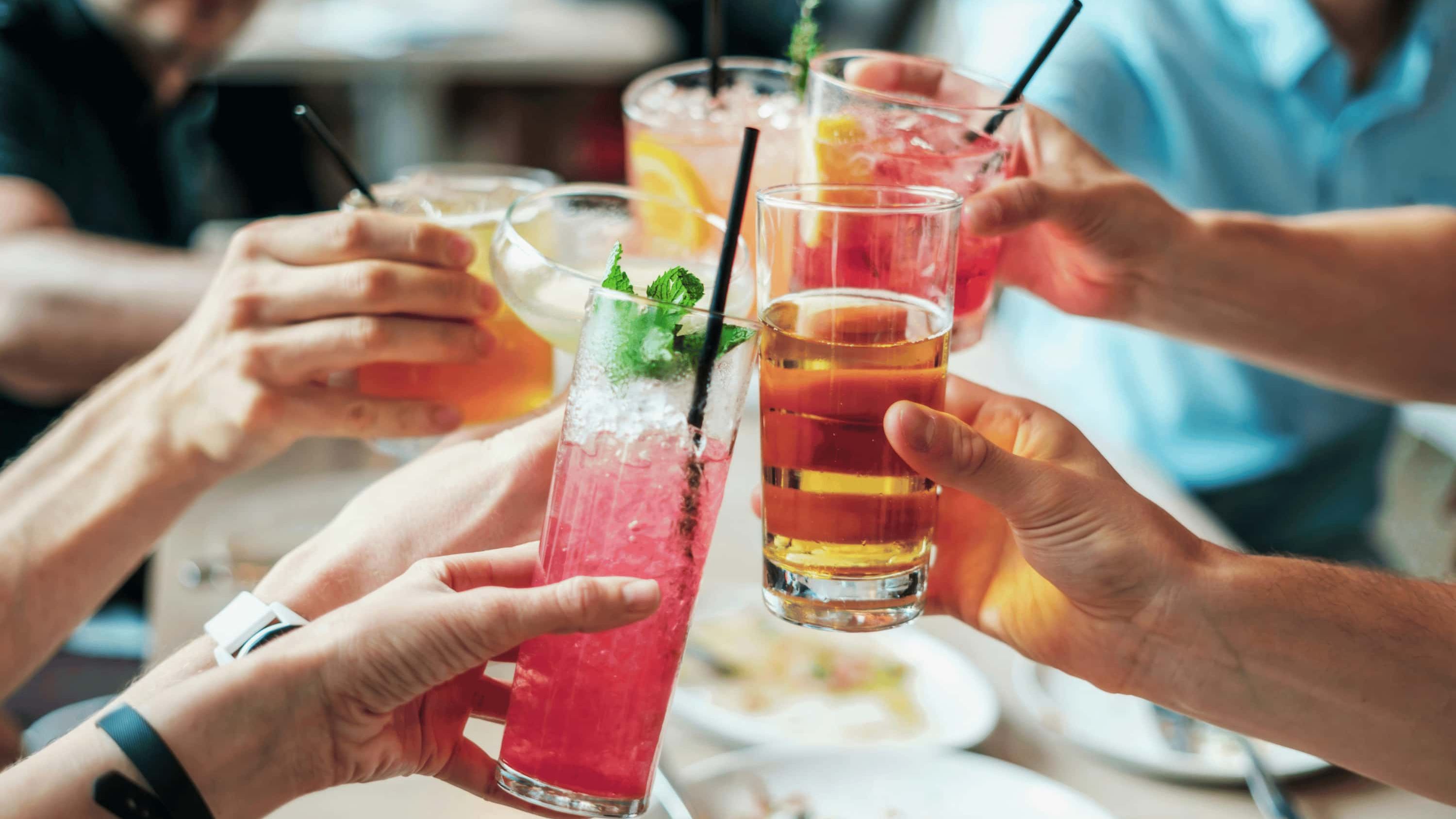 People practicing zebra striping drinking by enjoying drinking a mix of alcohol and non-alcoholic drinks