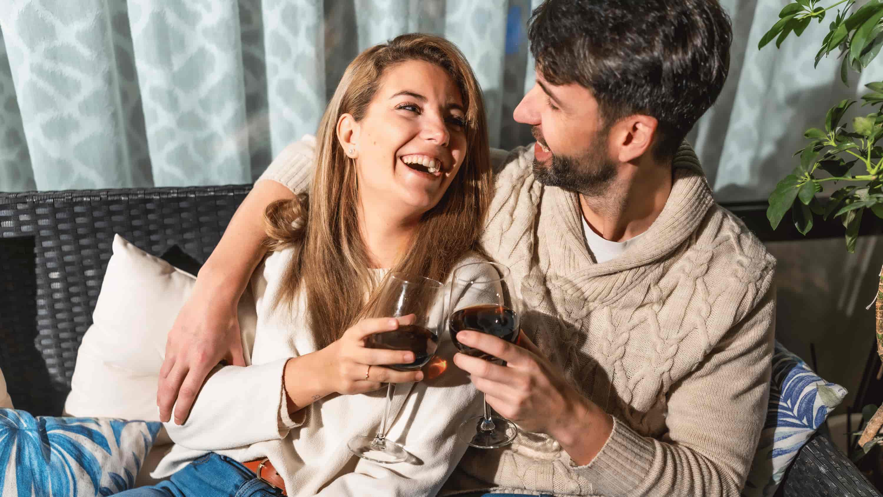 A woman and a man sharing a relaxed evening together — representing the different ways alcohol affects women's and men's bodies