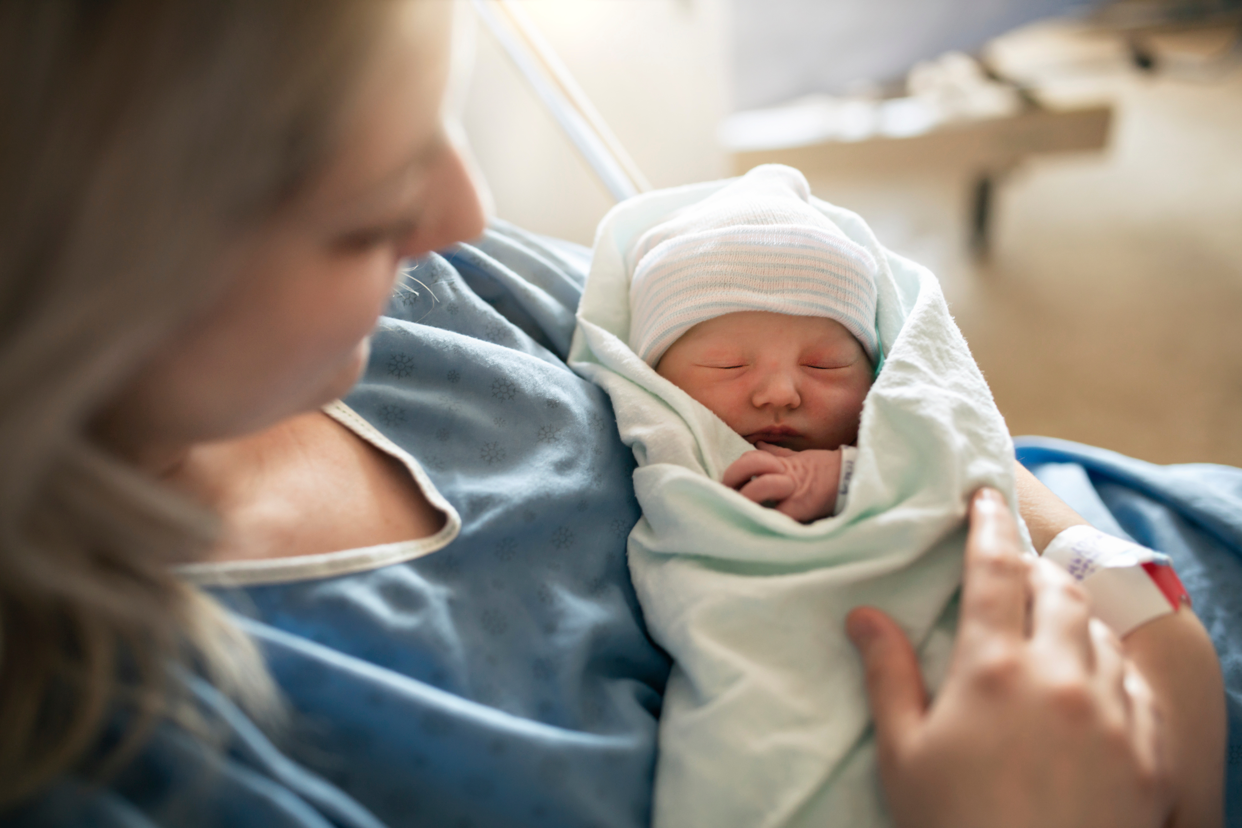 Mother holding her newborn after a supported fertility and pregnancy journey