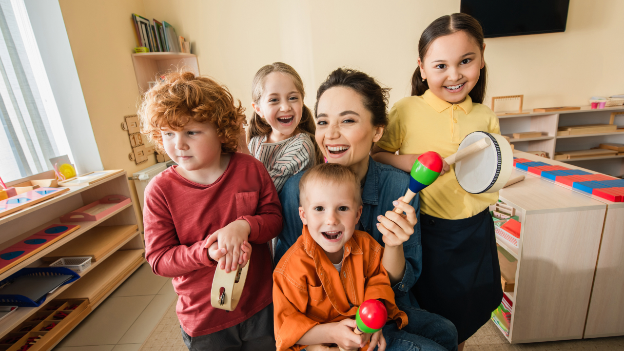 A mom and three children play percussion instruments together at home, exploring music as a family.