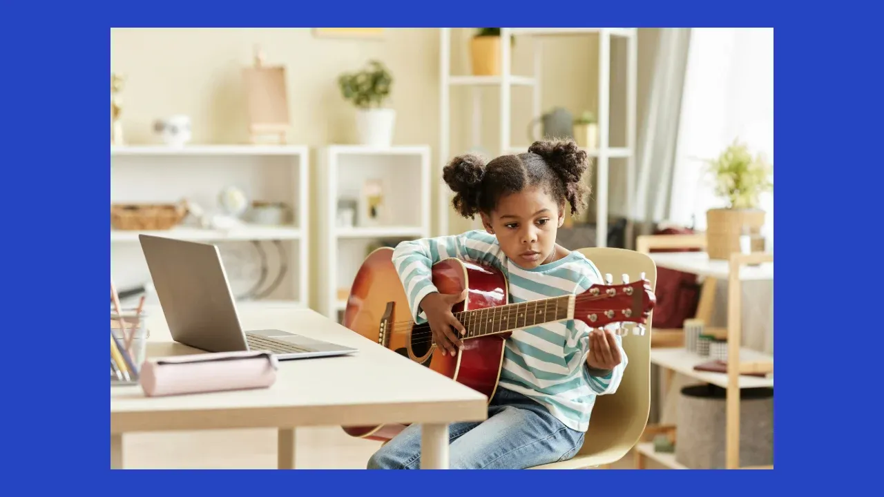 Young homeschool student learning guitar online at home with a laptop