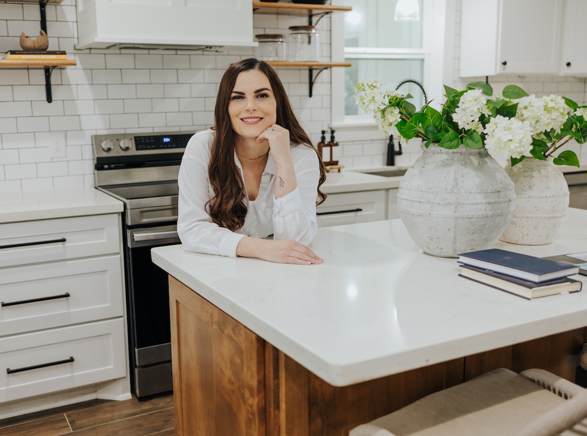 Katie smiling as she leans on her kitchen island