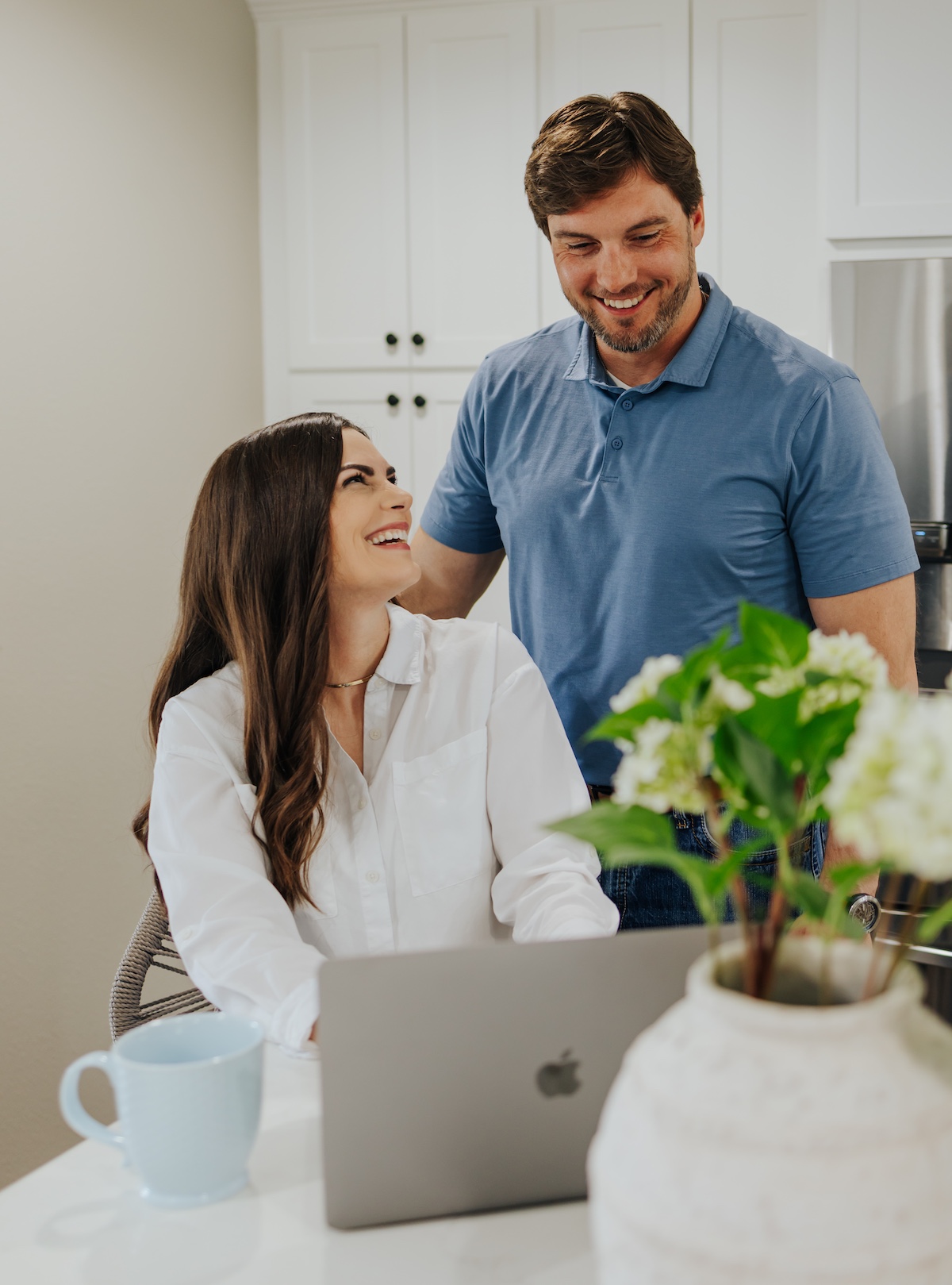 Kathryn and Chase Fayle smiling at a laptop