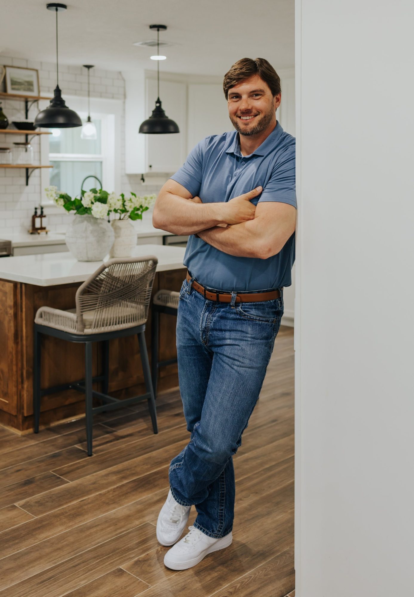 Chase smiling as he leans in a doorway by the kitchen