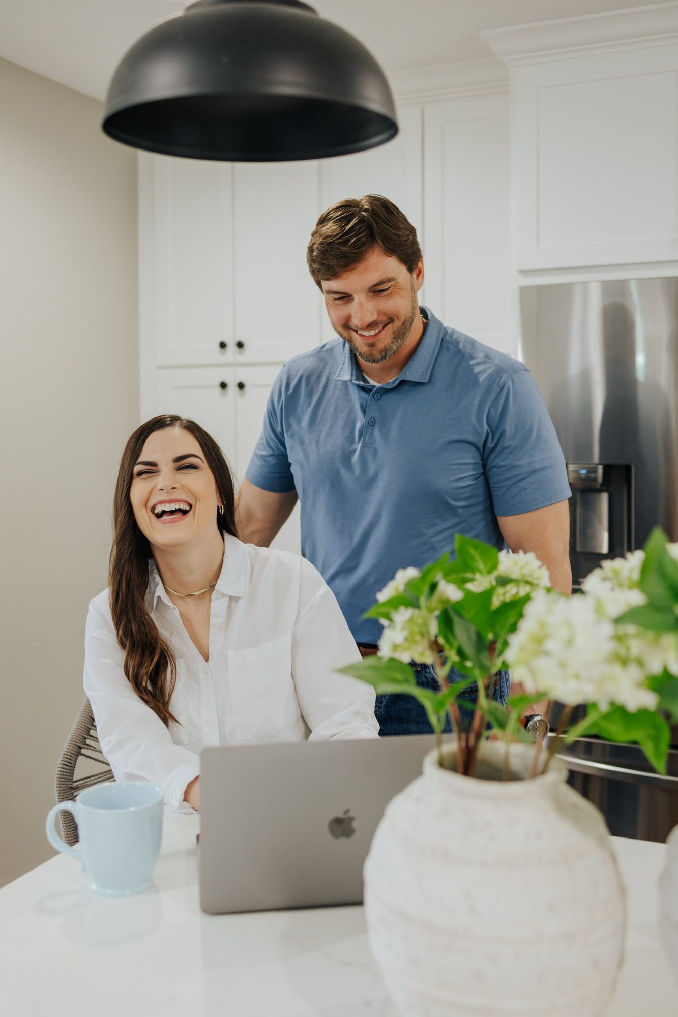 Katie laughing as Chase smiles beside her