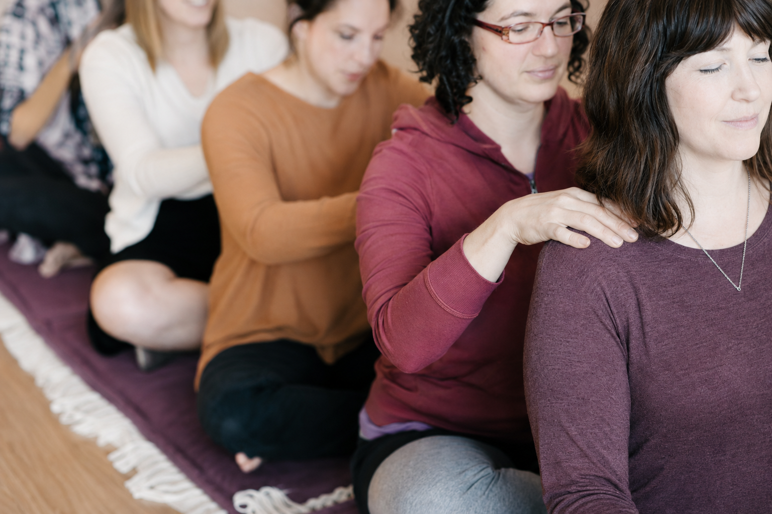 Doulas practicing hands-on comfort measures on each other during training