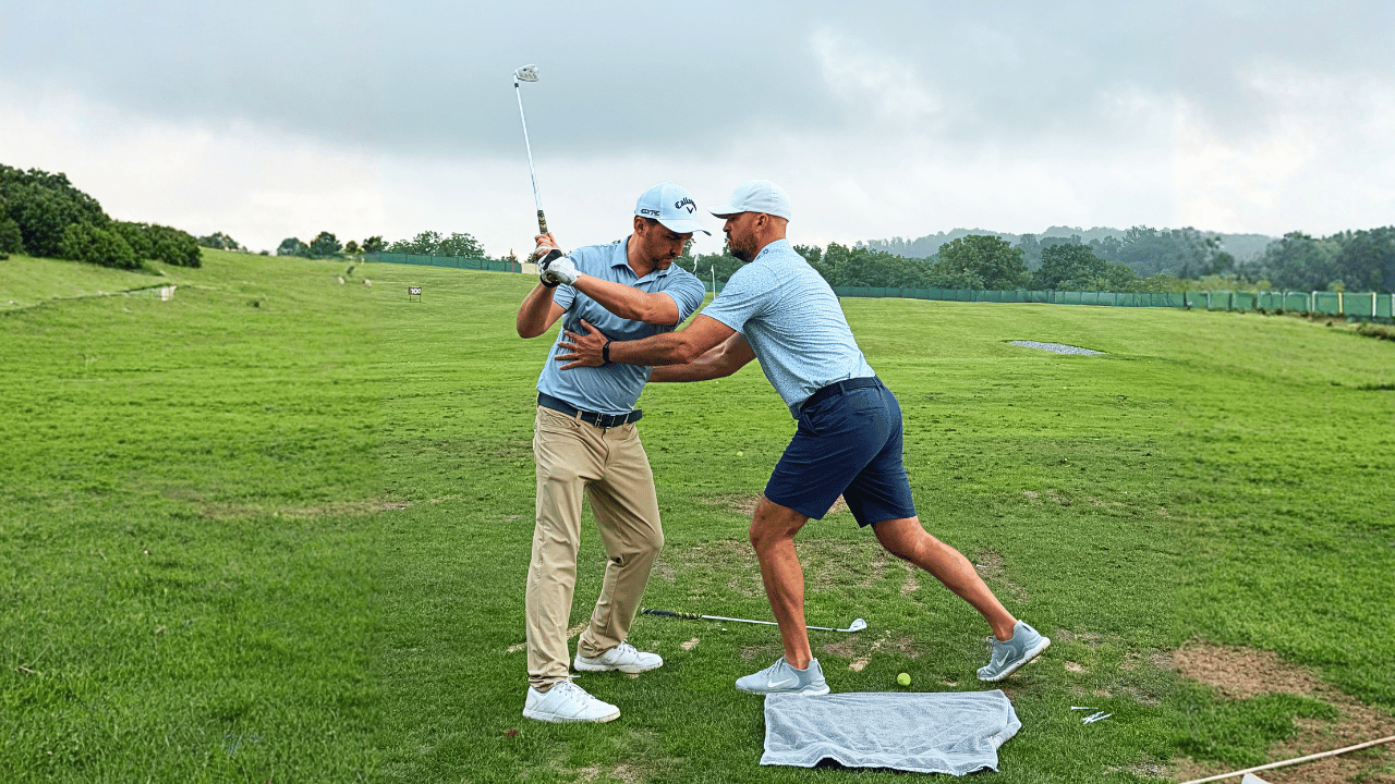Eric Cogorno coaching a student during golf school about what the course is actually testing