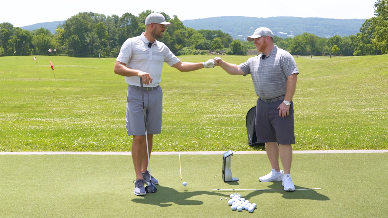 Eric Cogorno working with John Hutzler a golf club fitter