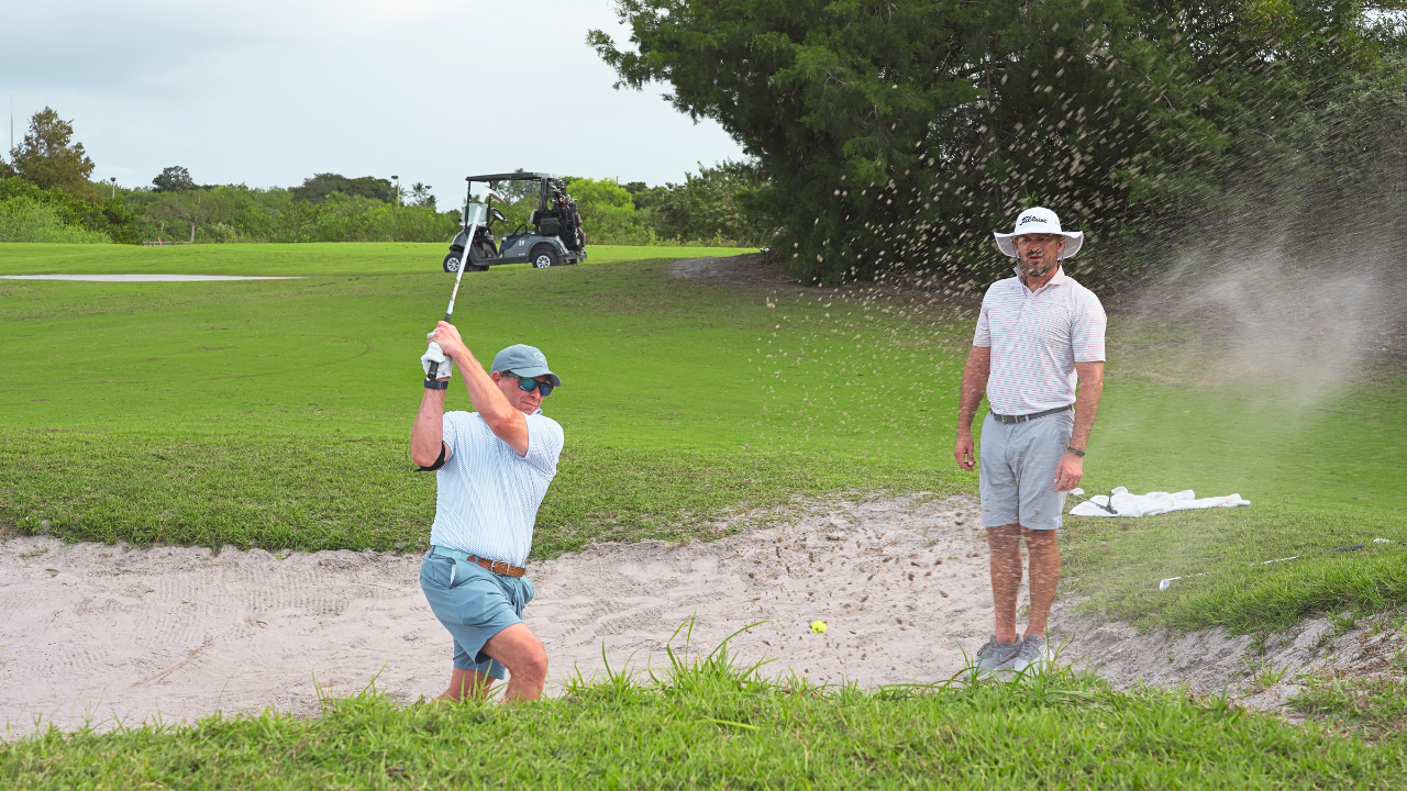 Eric Cogorno coaching a student about proper bunker shot setup