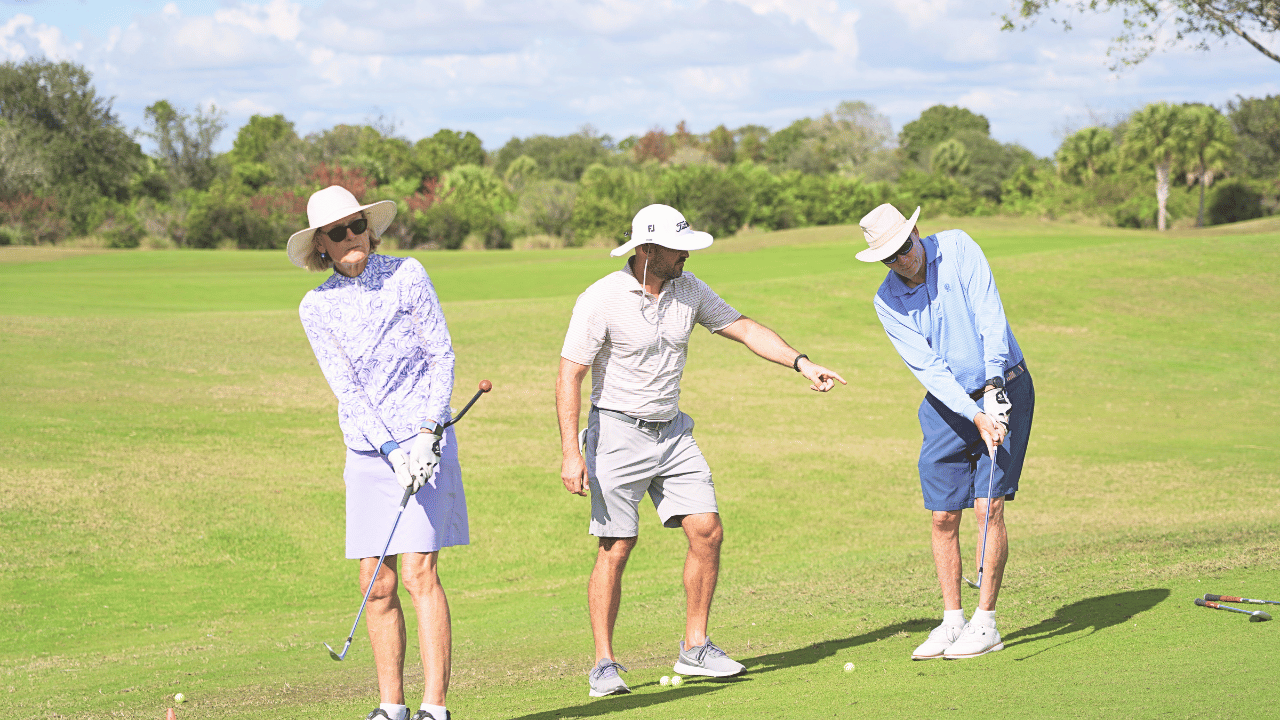 Eric Cogorno coaching a husband and wife duo at Osprey Point Golf Course