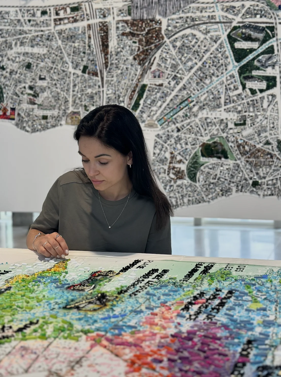 Valerija Fic hand-embroidering a beaded map of Paris at her atelier workspace, School of Couture