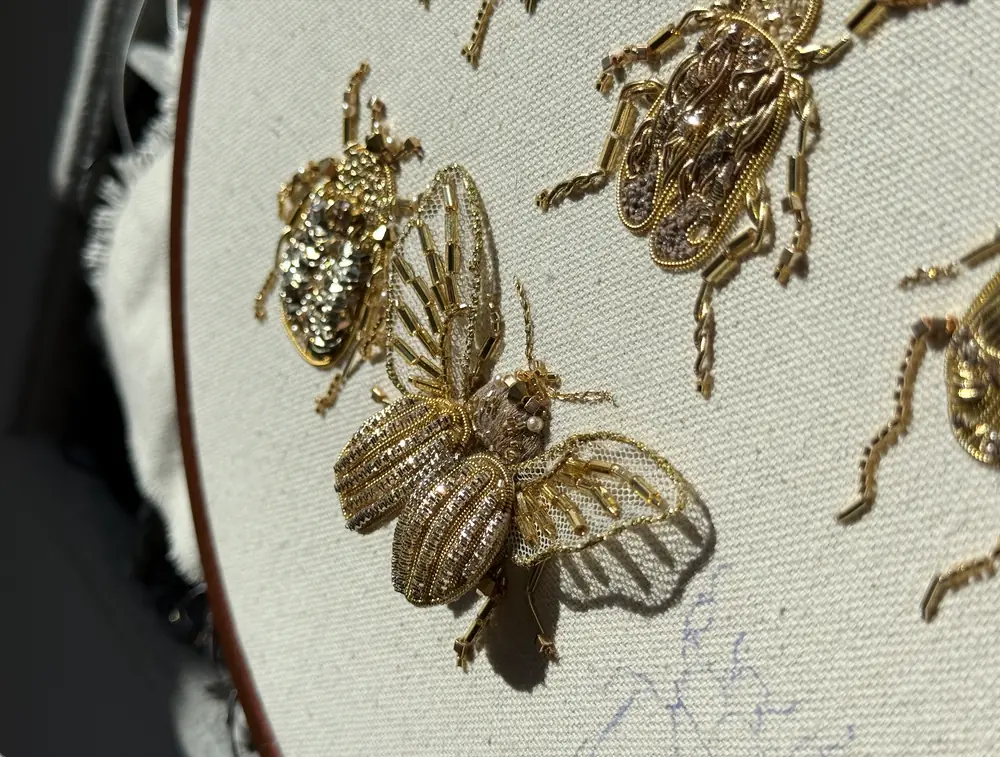 Colorado beetle goldwork embroidery close-up with 3D beaded wings and layered body
