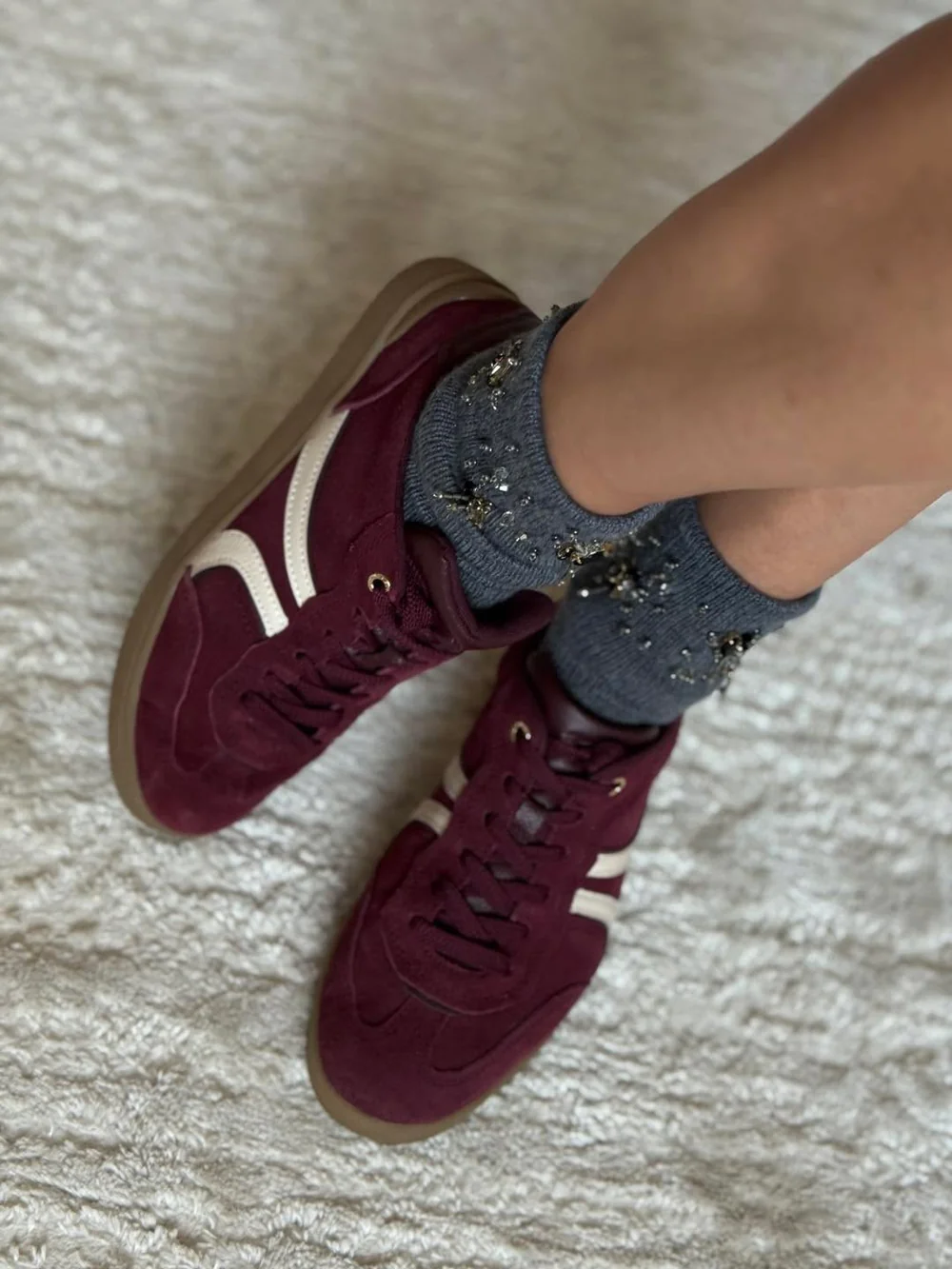 Bead-embroidered grey socks worn with burgundy suede sneakers, couture styling