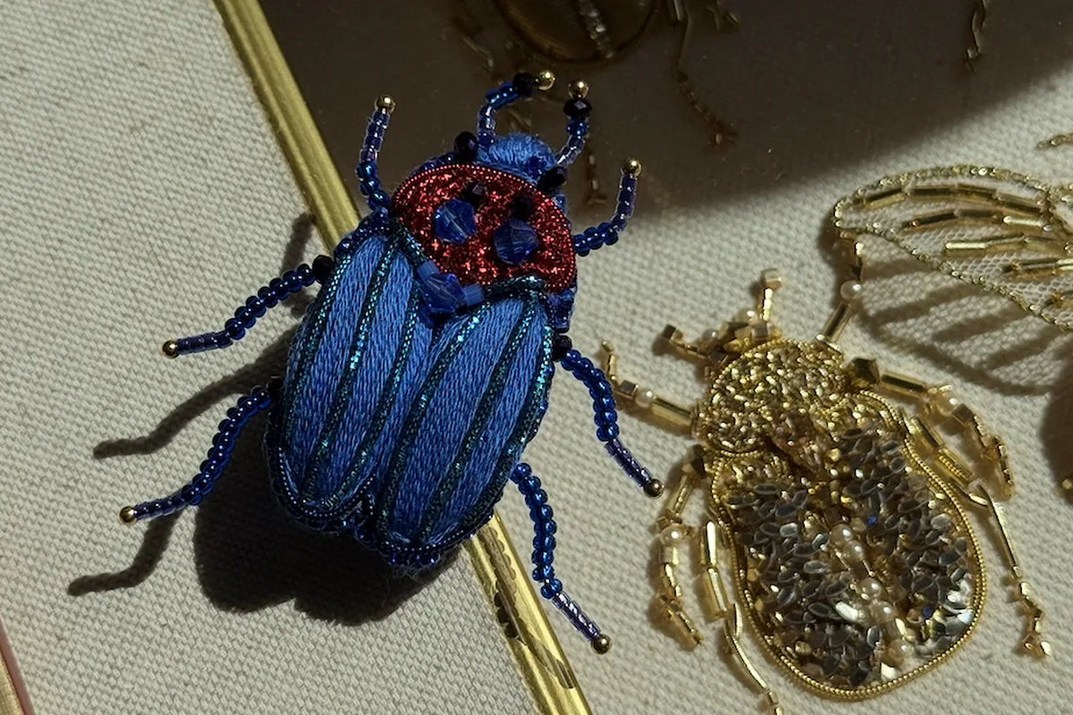 Blue goldwork beetle finished as a wearable brooch, School of Couture